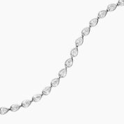 Pear-cut moissanite bezel tennis bracelet in white gold vermeil, close-up detail.