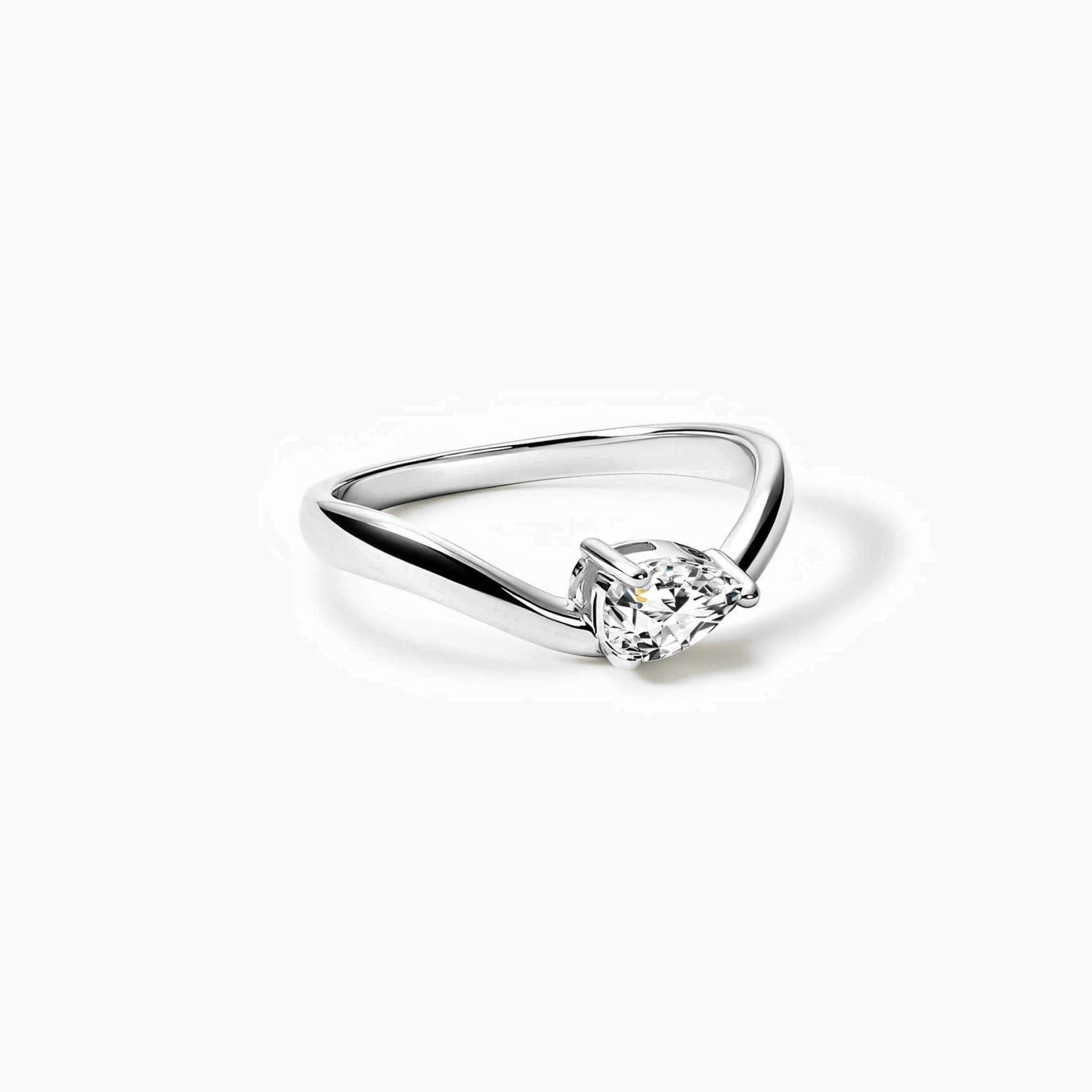 Pear-cut moissanite chevron ring in white gold vermeil, angled view.