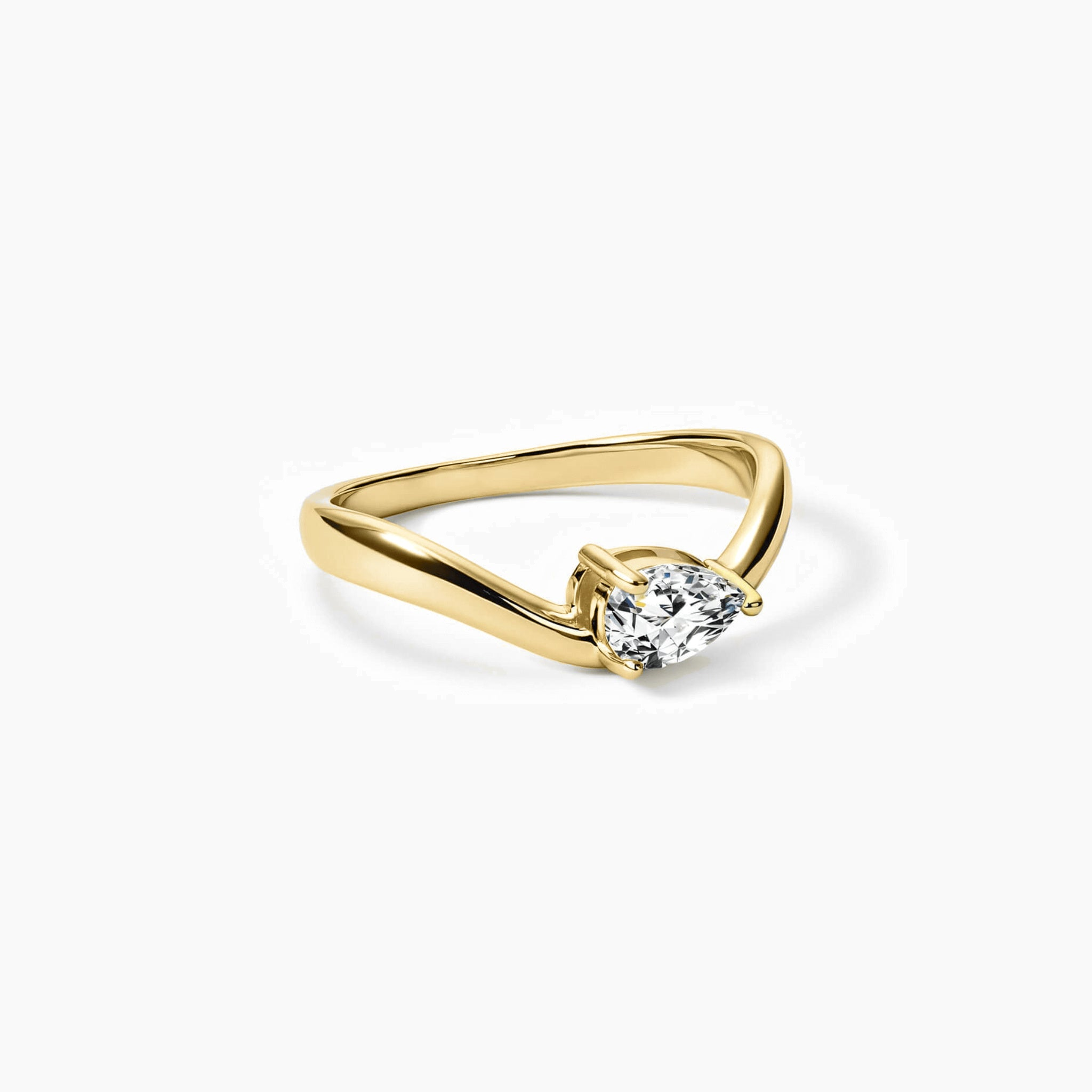 Pear-cut moissanite chevron ring in yellow gold vermeil, angled view.