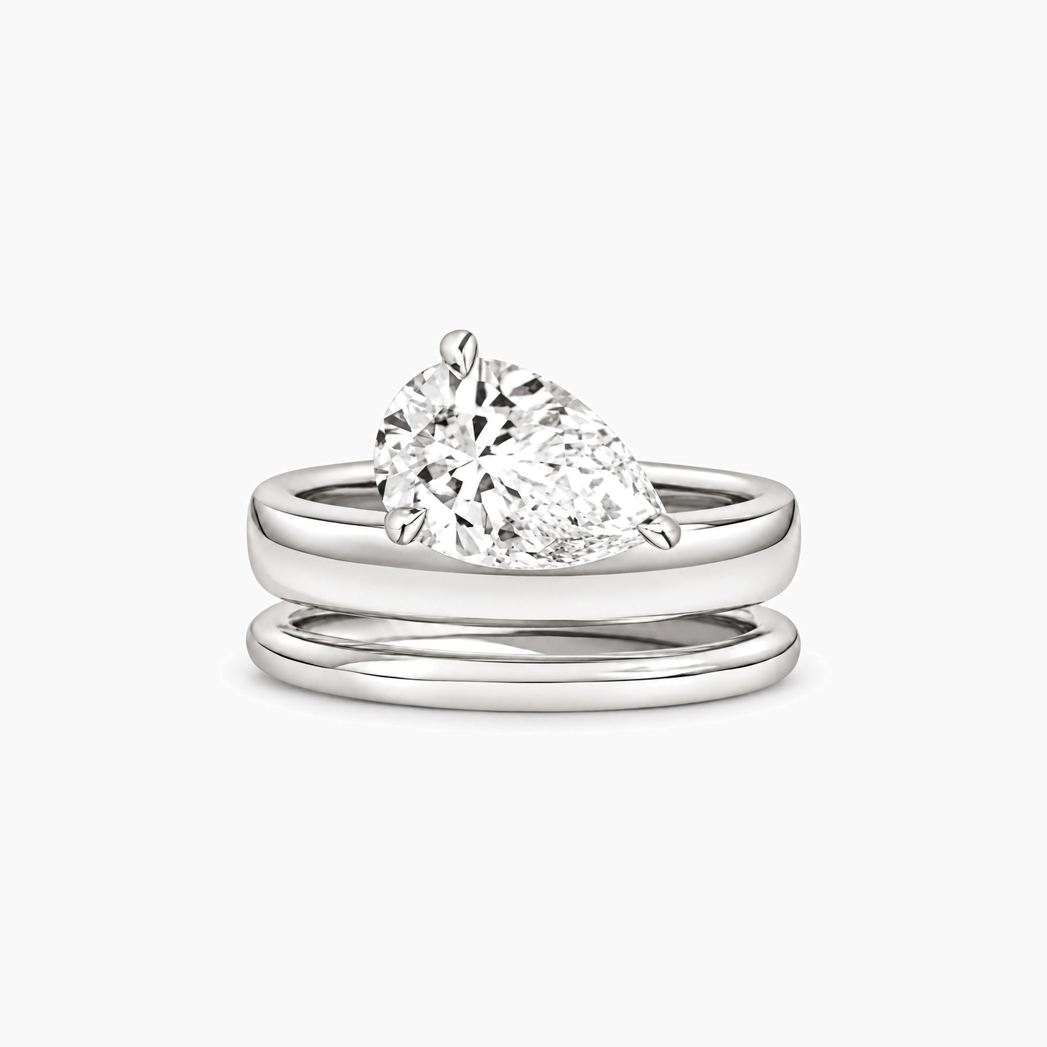 Pear-cut moissanite double-band solitaire ring in white gold vermeil, front view.