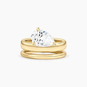 Pear-cut moissanite double-band solitaire ring in yellow gold vermeil, front view.