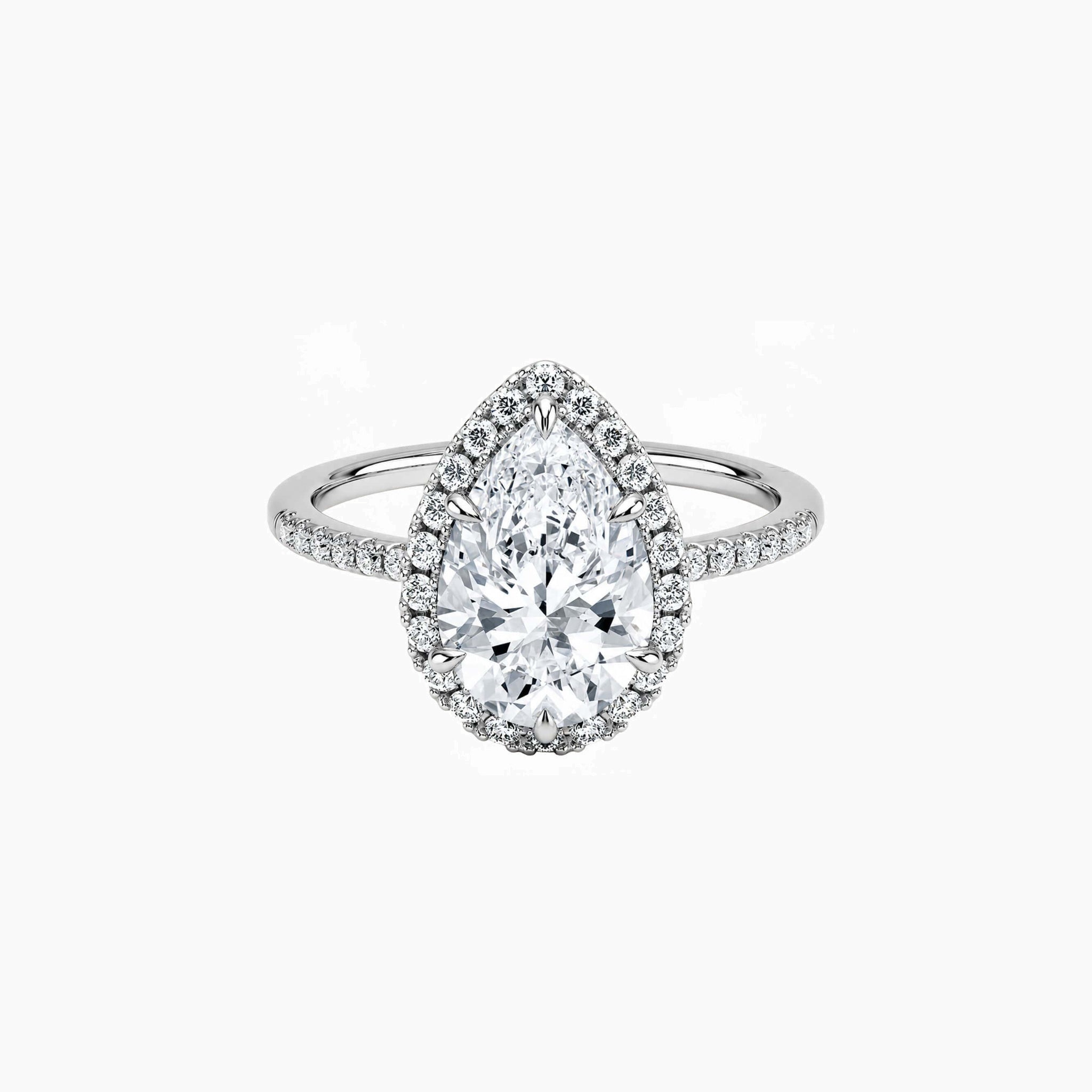 Pear-cut moissanite halo ring with pavé band in white gold vermeil, front view.