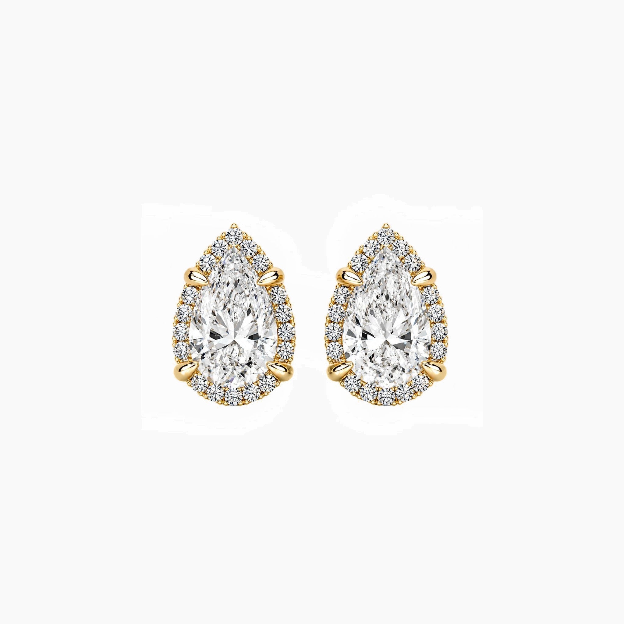 Pear-cut moissanite halo stud earrings in yellow gold vermeil, front view.