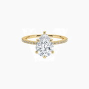 Pear-cut moissanite hidden halo ring with pavé band in yellow gold vermeil, front view.