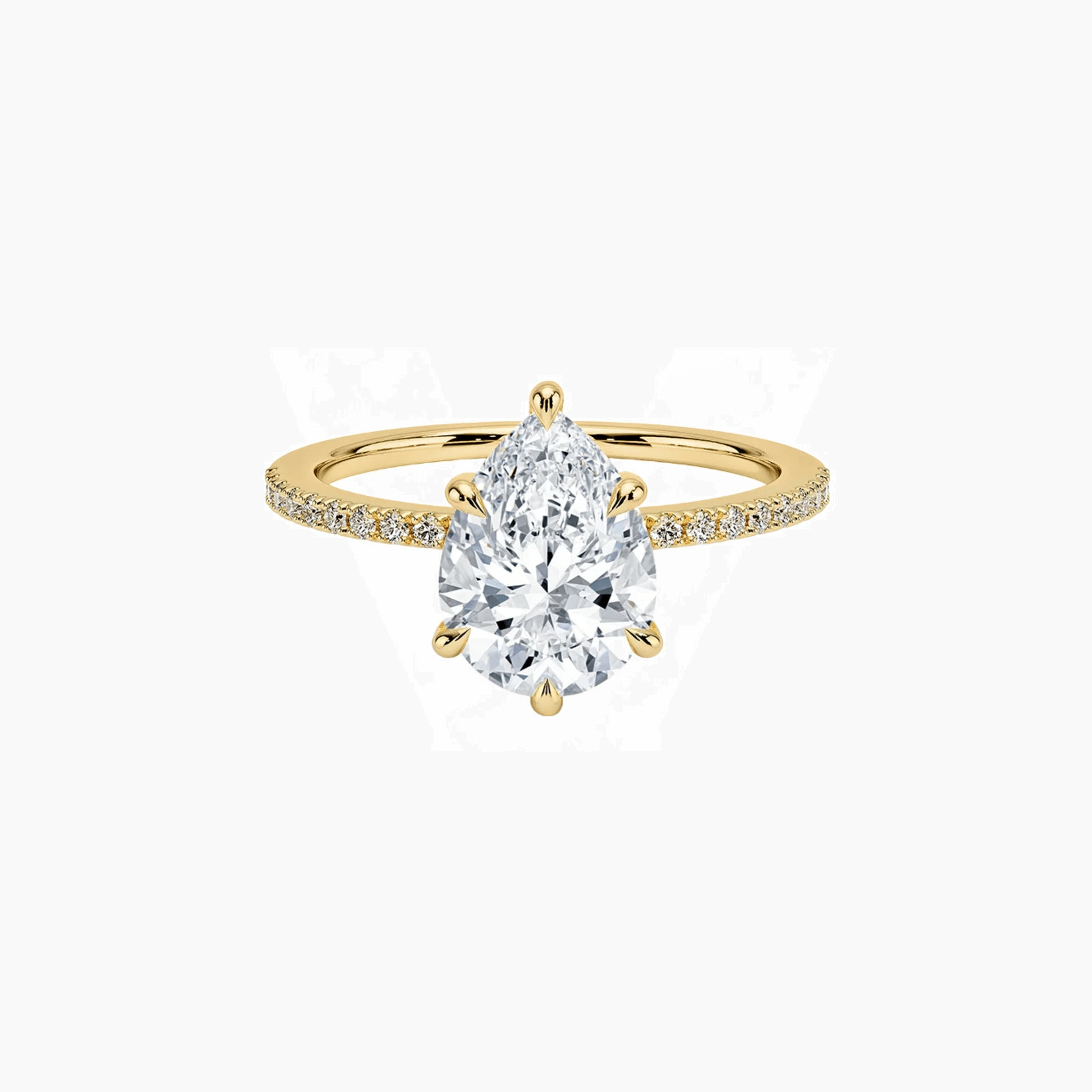 Pear-cut moissanite hidden halo ring with pavé band in yellow gold vermeil, front view.