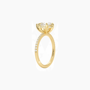Pear-cut moissanite hidden halo ring with pavé band in yellow gold vermeil, side view.