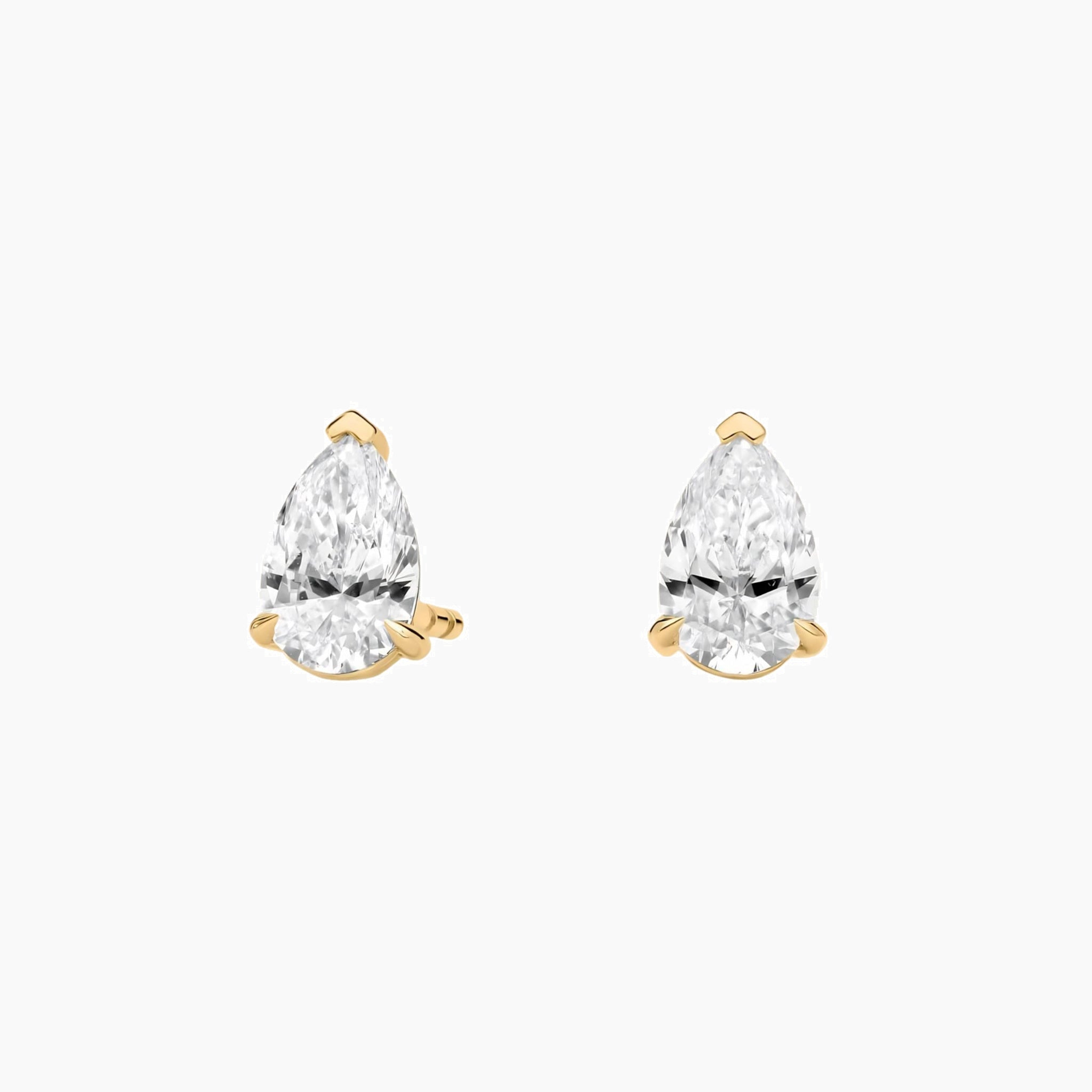 Pear-cut moissanite stud earrings in yellow gold vermeil, front view.