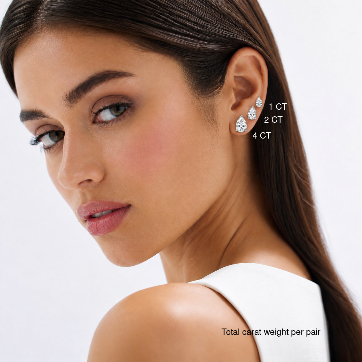 Pear-cut moissanite stud earrings worn on a model, comparing 1, 2 and 4 ct total carat weight per pair.