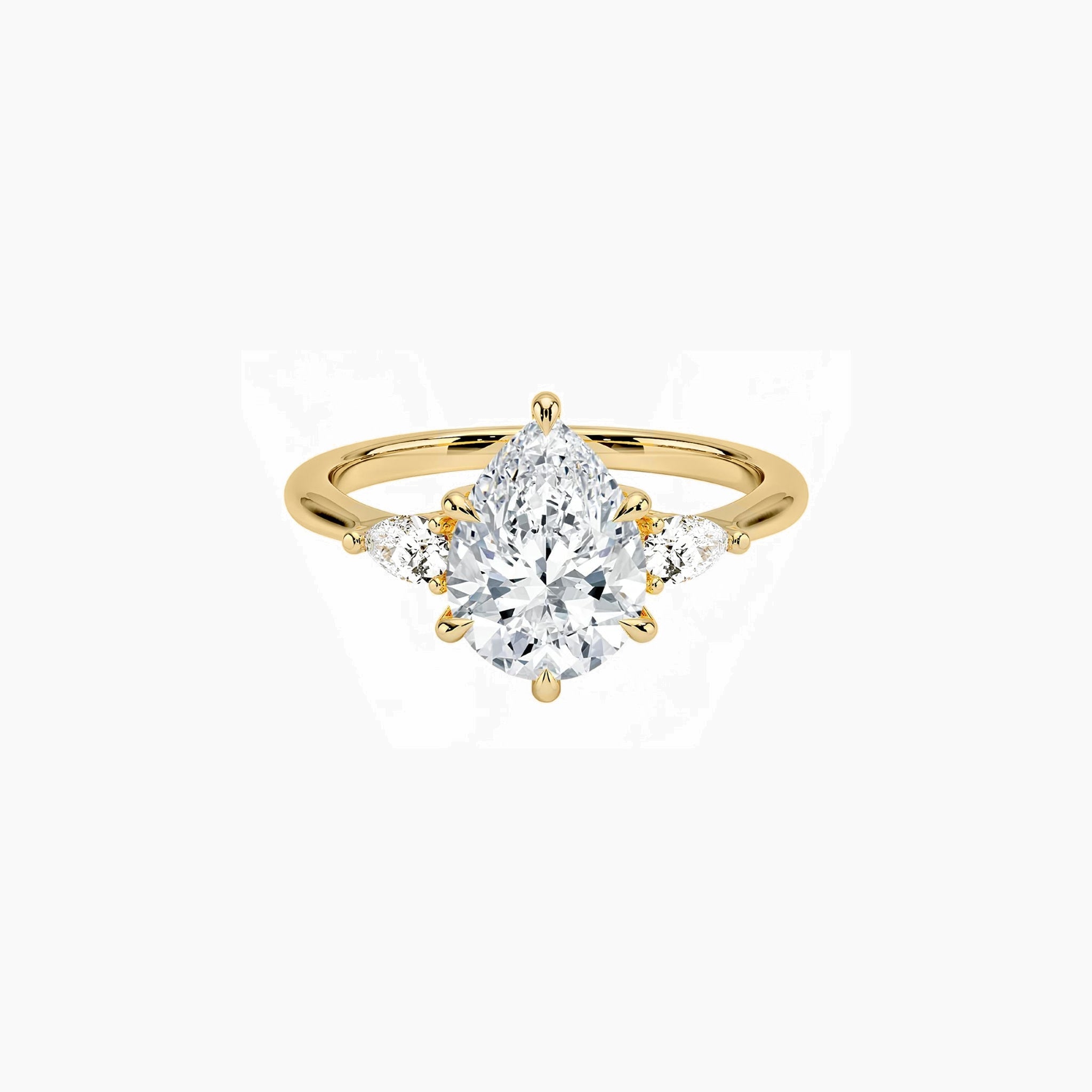 Pear-cut moissanite three-stone ring in yellow gold vermeil, front view.