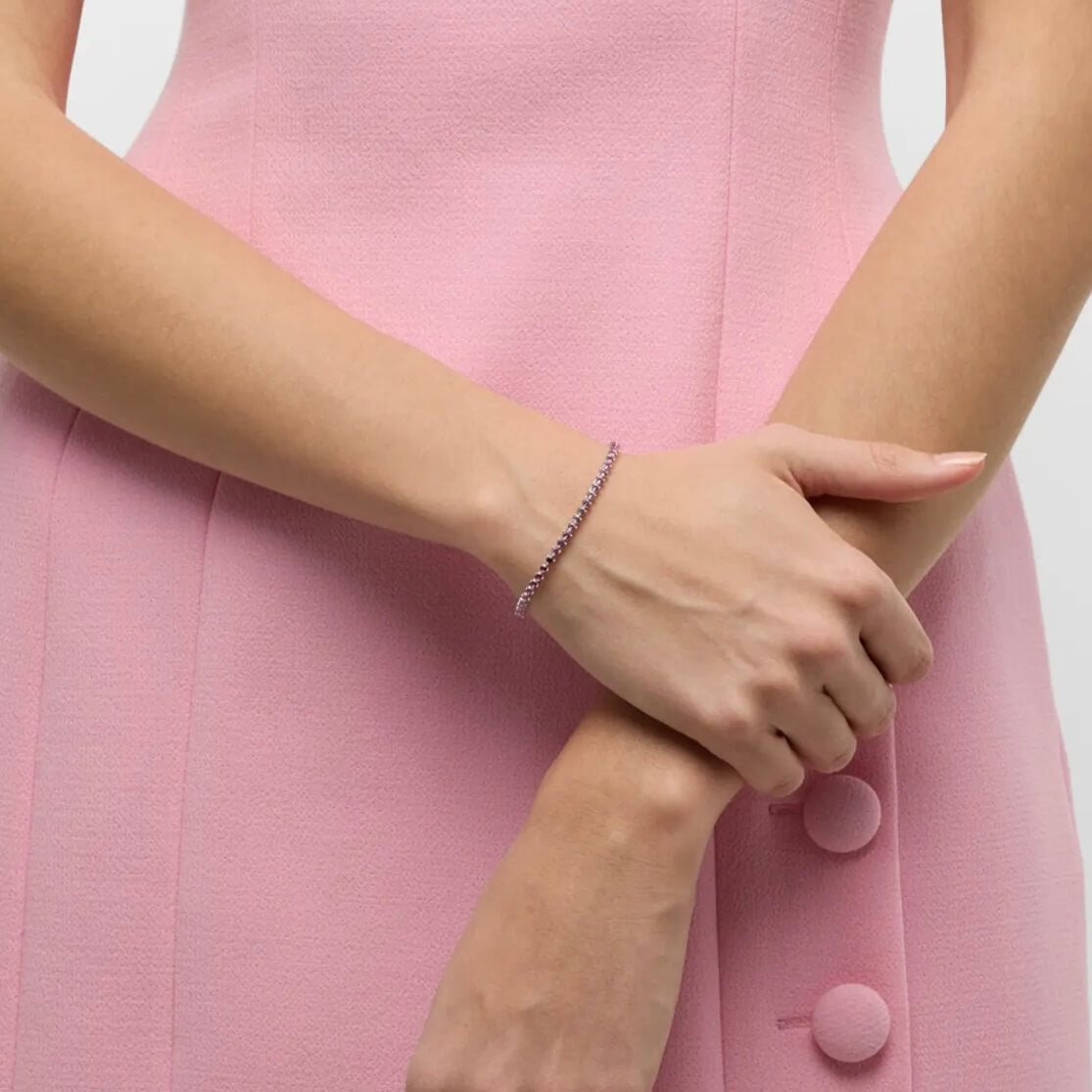 Pink ombré moissanite tennis bracelet worn on the wrist.