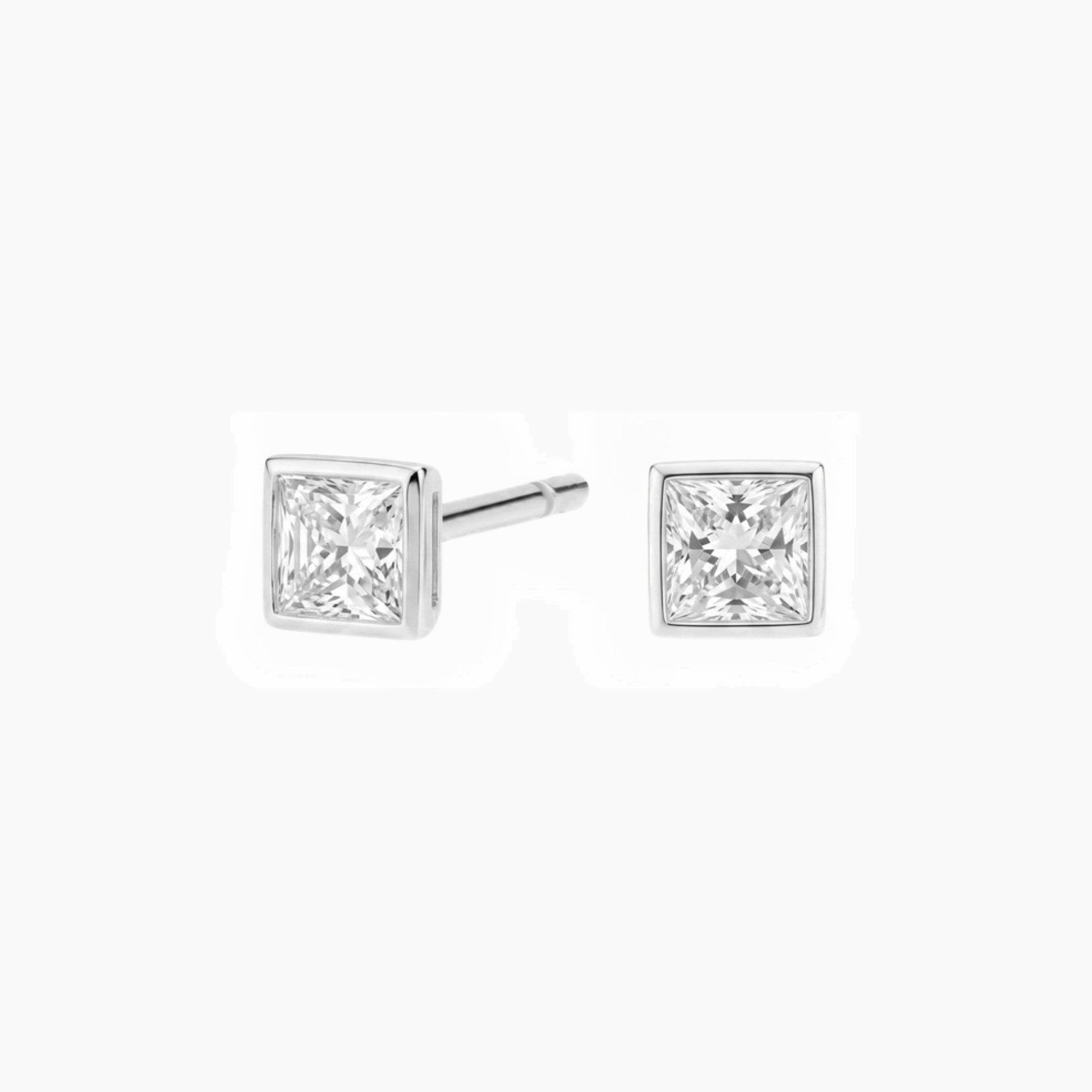 Princess-cut moissanite bezel stud earrings in white gold vermeil, front and side views.