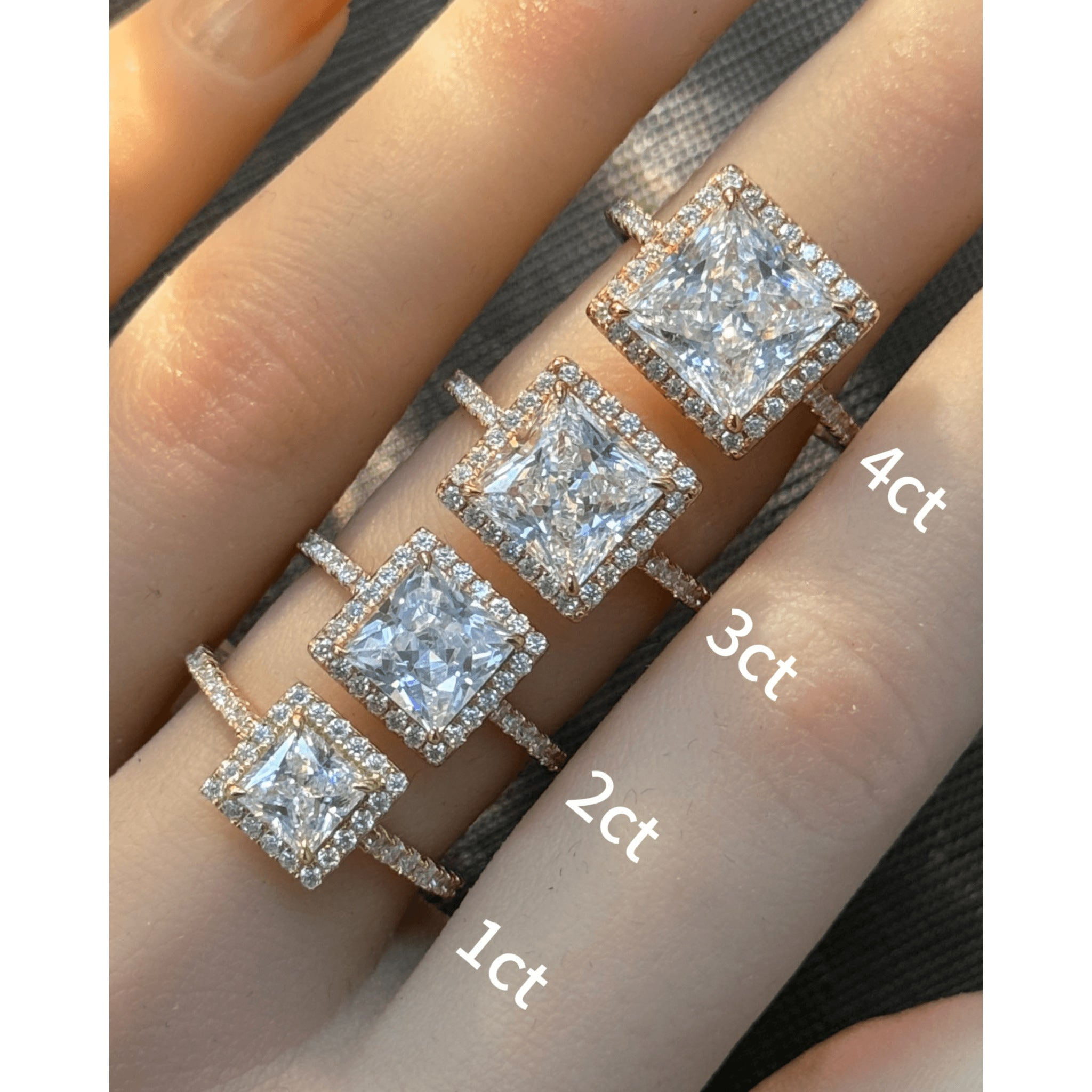 Princess-cut moissanite halo ring with pavé band rings arranged across fingers for a carat-size comparison.