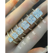 Princess-cut moissanite hidden halo ring with pavé band rings arranged across fingers for a carat-size comparison.