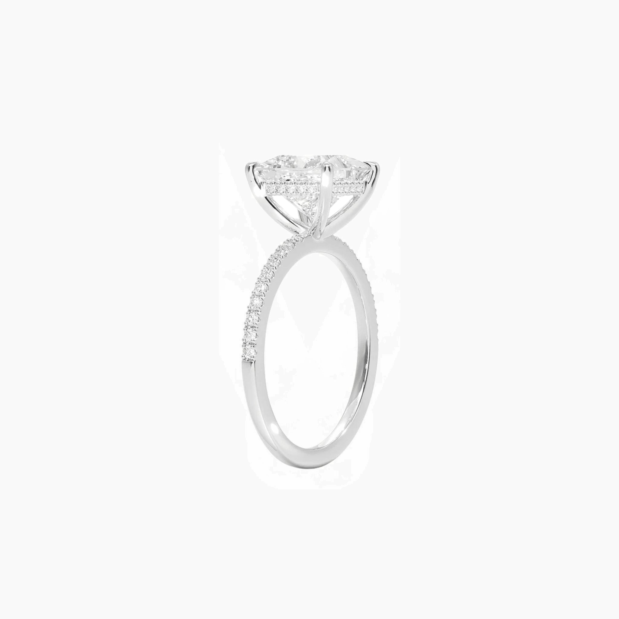 Princess-cut moissanite hidden halo ring with pavé band in white gold vermeil, side view.