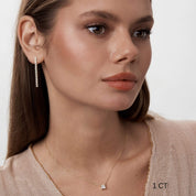 Princess-cut moissanite pendant necklace worn at the neckline.