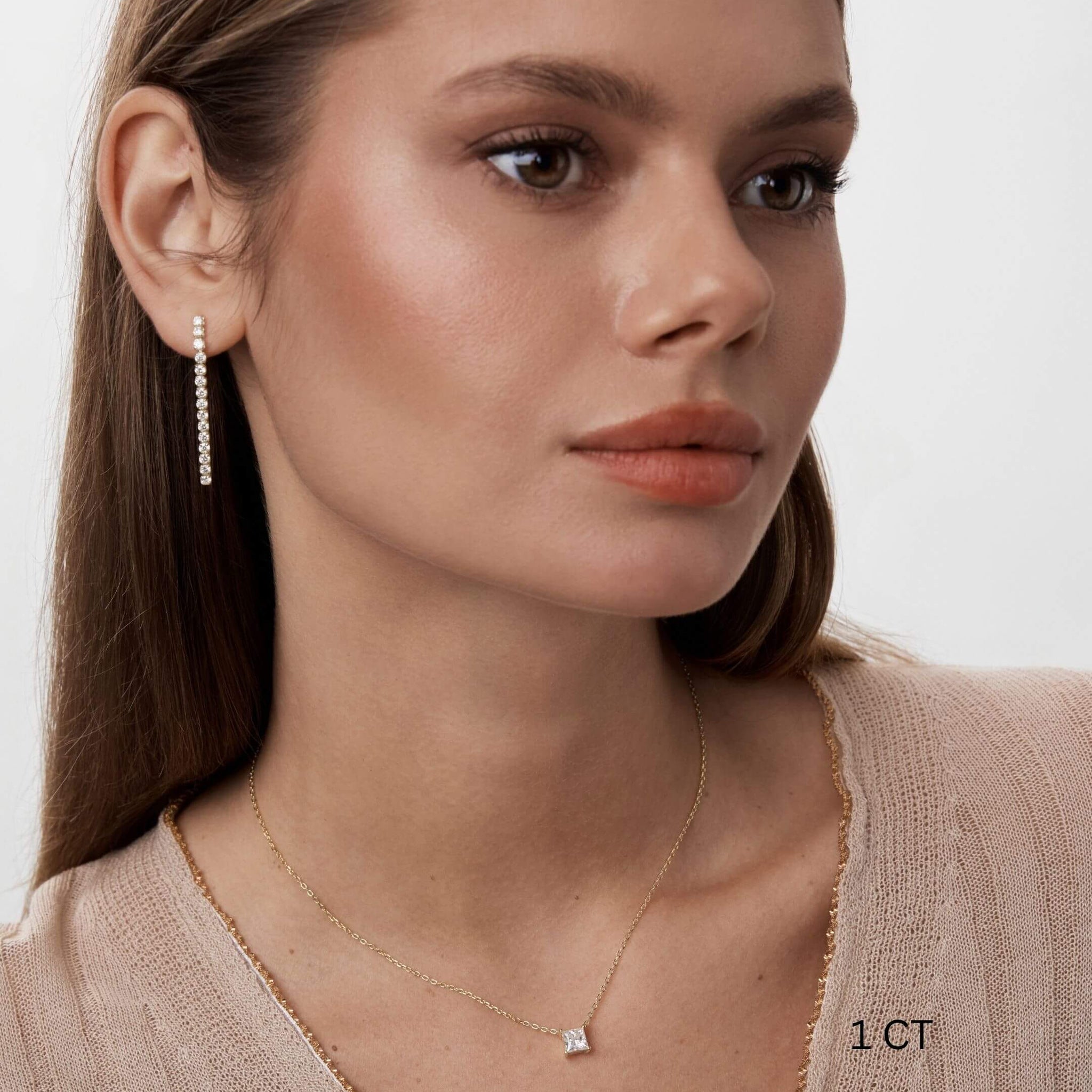 Princess-cut moissanite pendant necklace worn at the neckline.