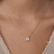 Princess-cut moissanite pendant necklace worn at the neckline.