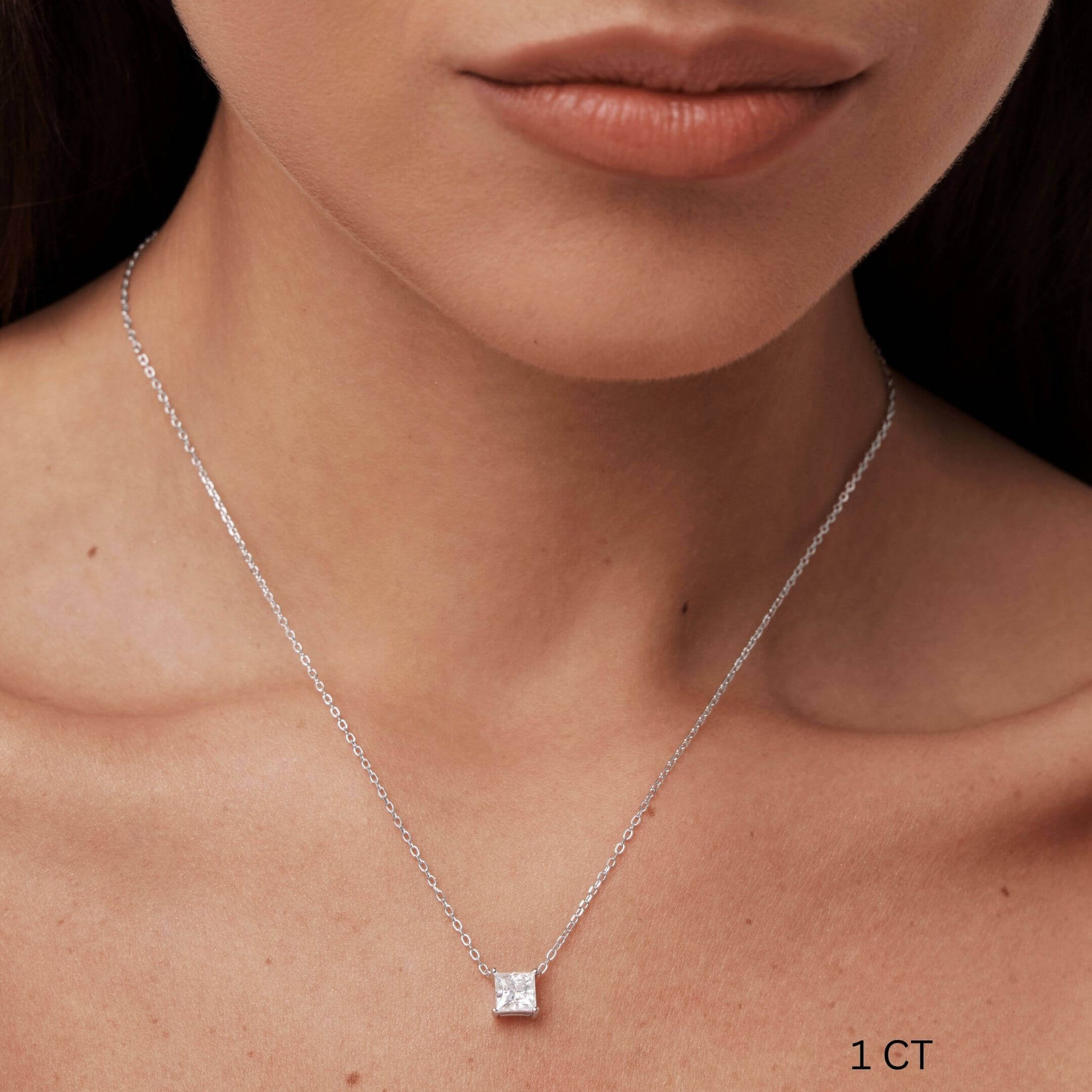 Princess-cut moissanite pendant necklace worn at the neckline.