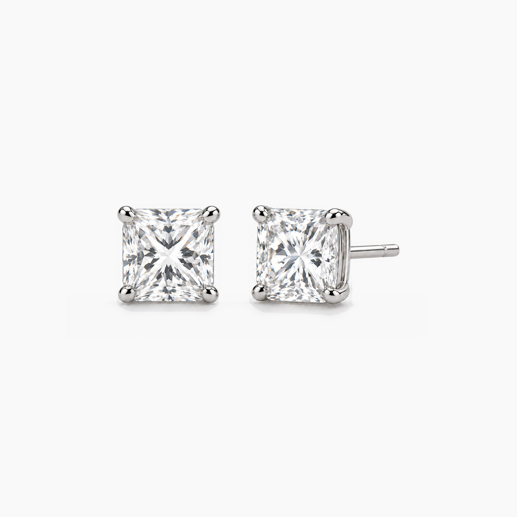 Princess-cut moissanite stud earrings in white gold vermeil, front and three-quarter views.