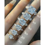Princess-cut moissanite three-stone ring rings arranged across fingers for a carat-size comparison.