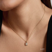 Radiant-cut moissanite bezel pendant necklace worn at the neckline.