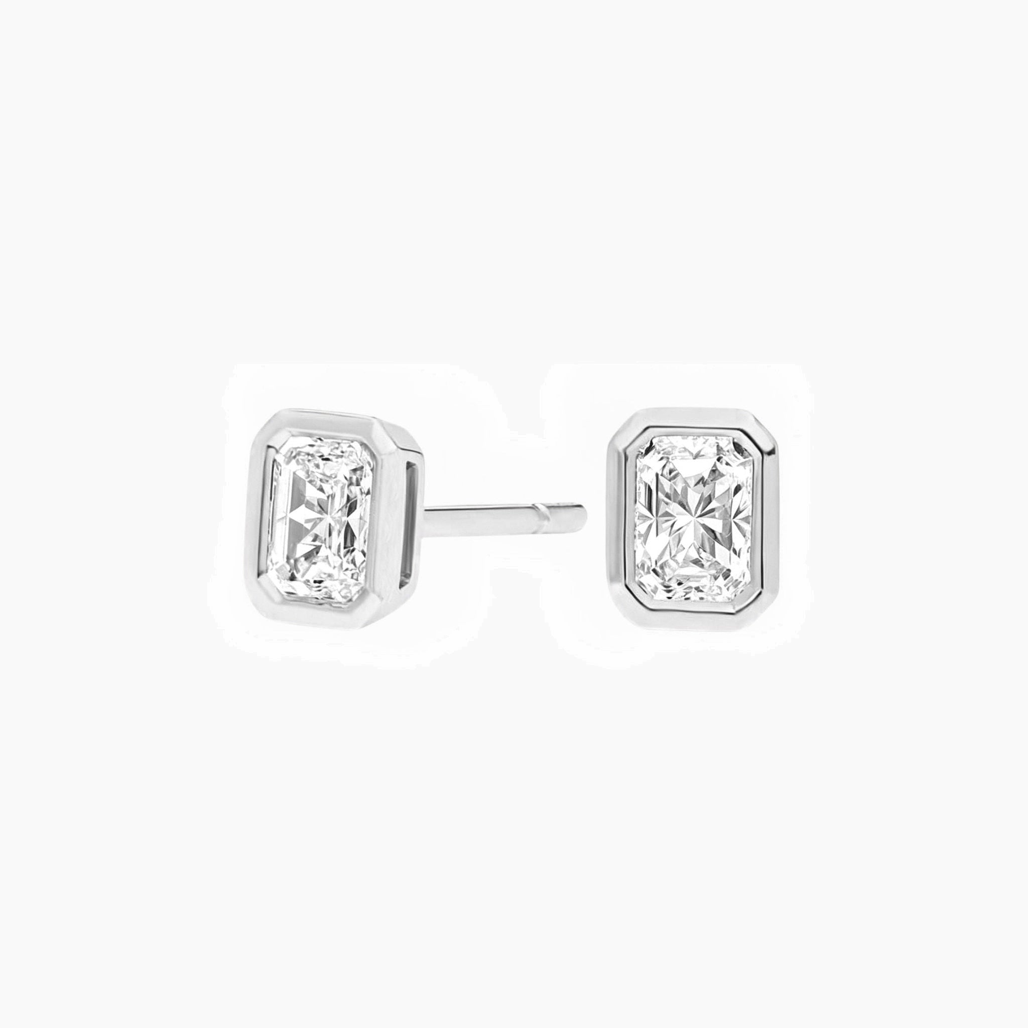 Radiant-cut moissanite bezel stud earrings in white gold vermeil, front and side views.