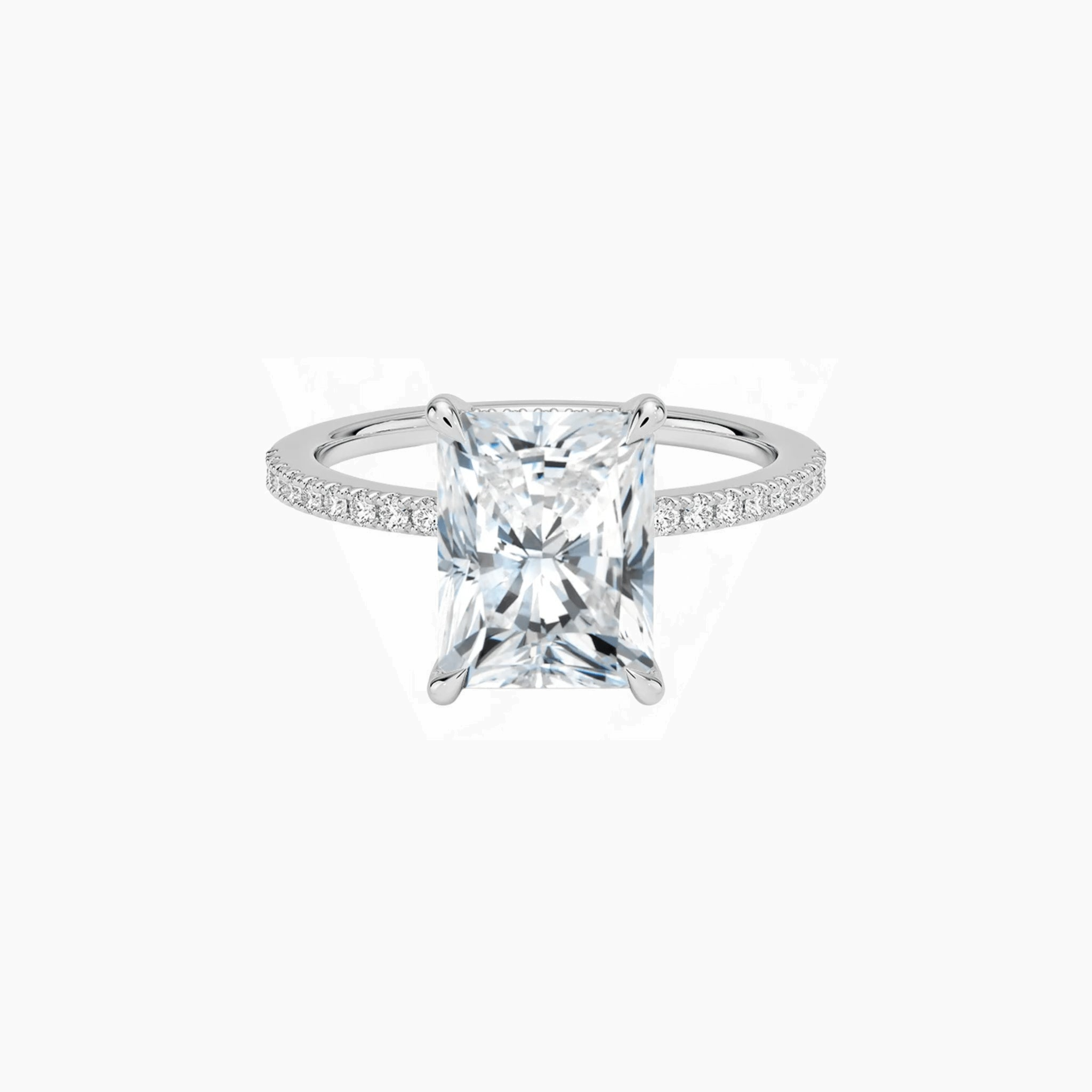Radiant-cut moissanite hidden halo ring with pavé band in white gold vermeil, front view.