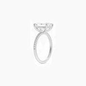 Radiant-cut moissanite hidden halo ring with pavé band in white gold vermeil, side view.