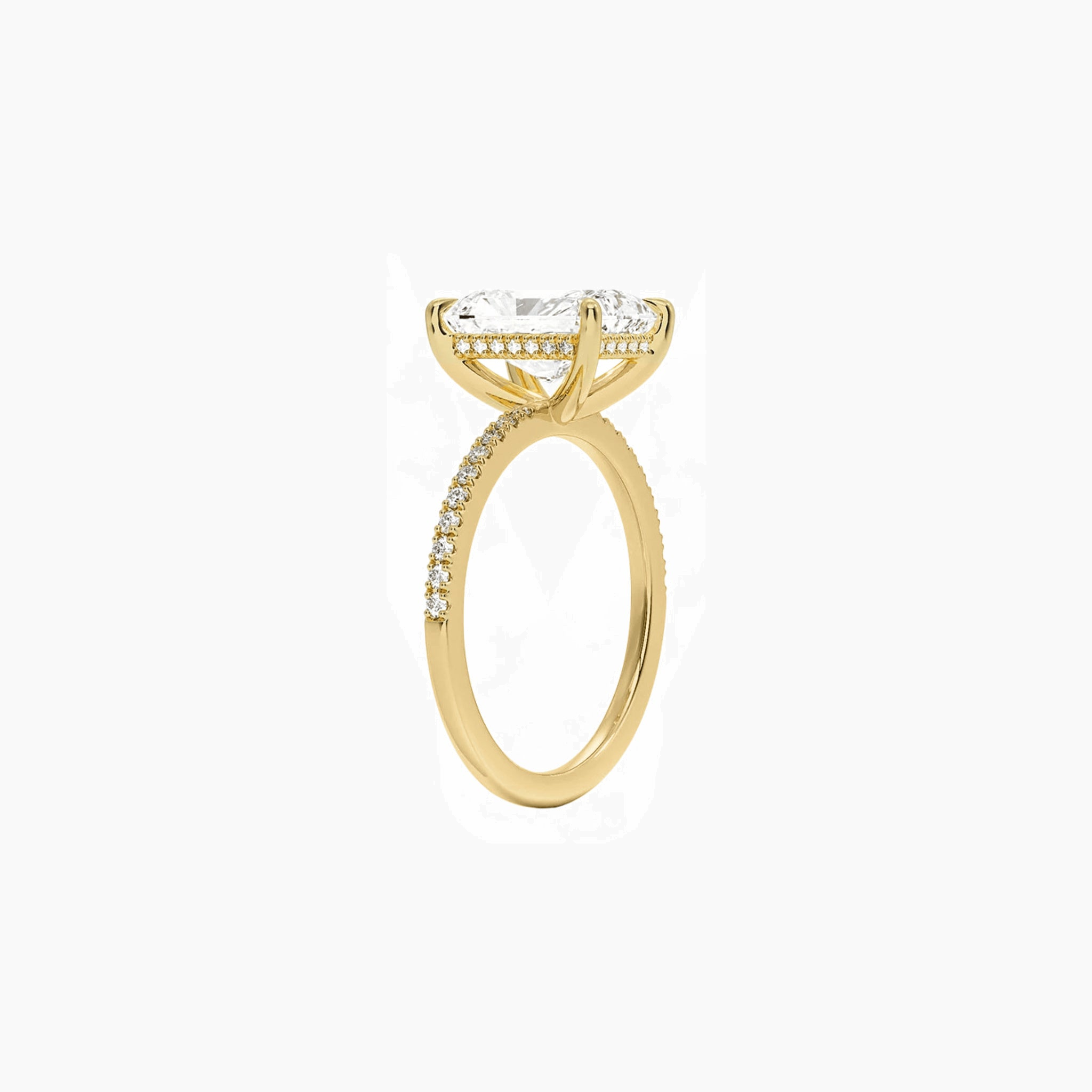 Radiant-cut moissanite hidden halo ring with pavé band in yellow gold vermeil, side view.