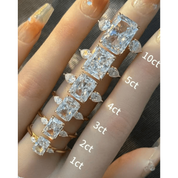 Radiant-cut moissanite three-stone ring rings arranged across fingers for a carat-size comparison.