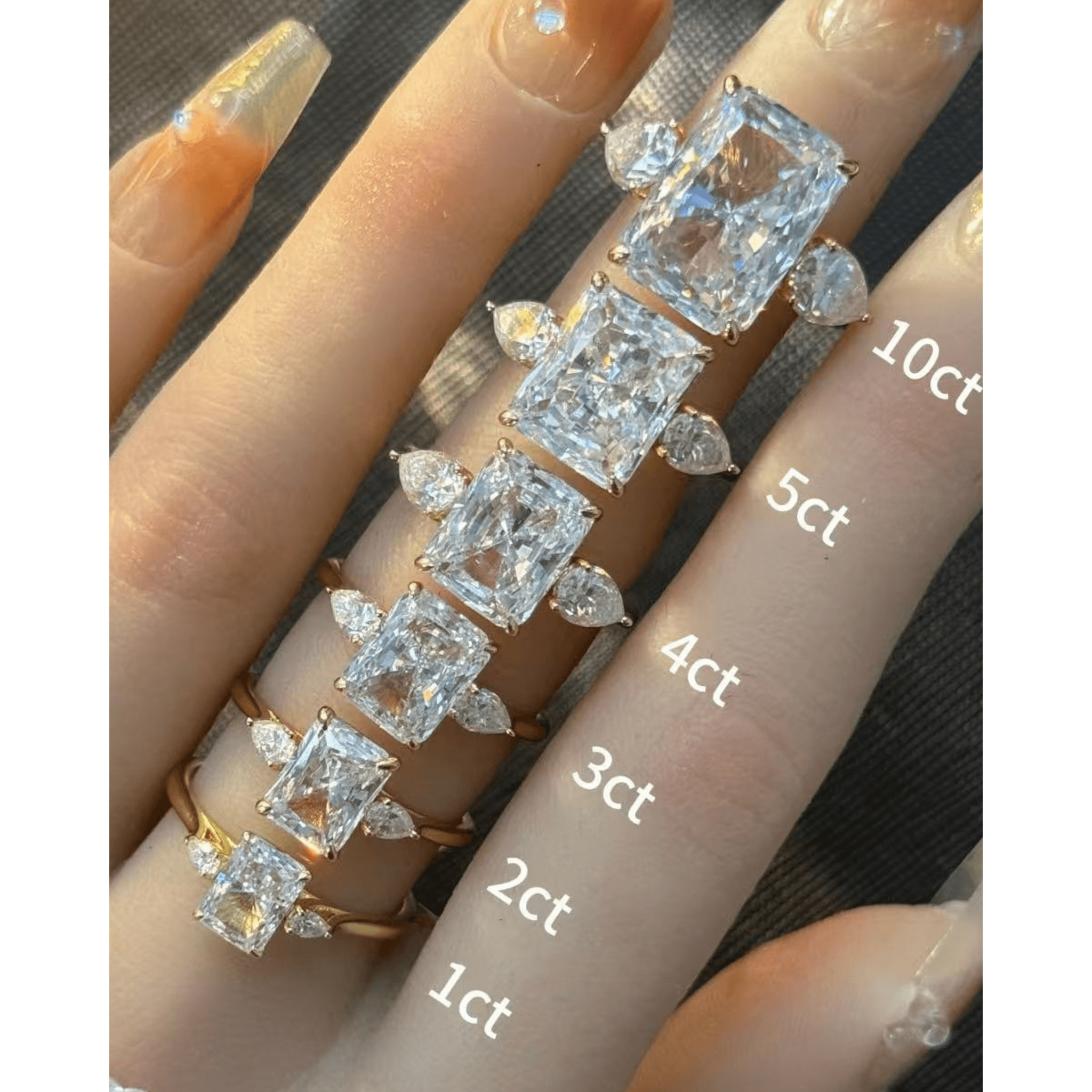 Radiant-cut moissanite three-stone ring rings arranged across fingers for a carat-size comparison.
