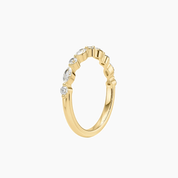 Round-cut and marquise-cut moissanite half eternity ring in yellow gold vermeil, side view.