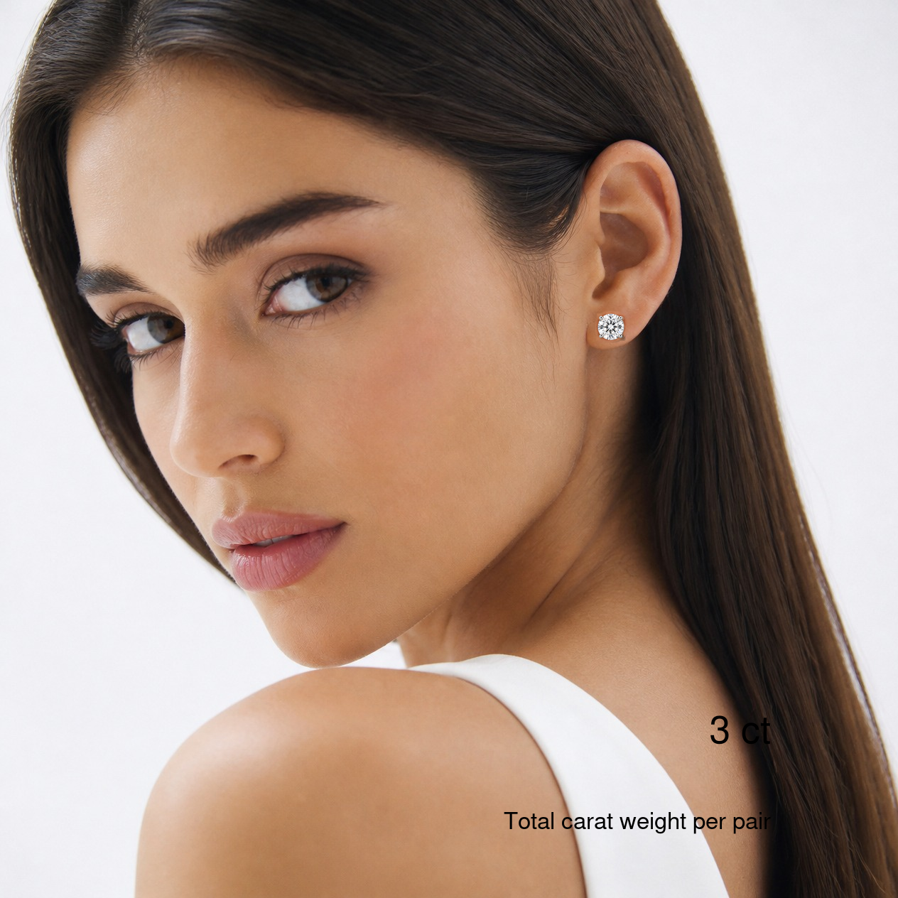 Round-cut lab-grown diamond stud earrings in white gold worn on a model, 3 ct total carat weight per pair.