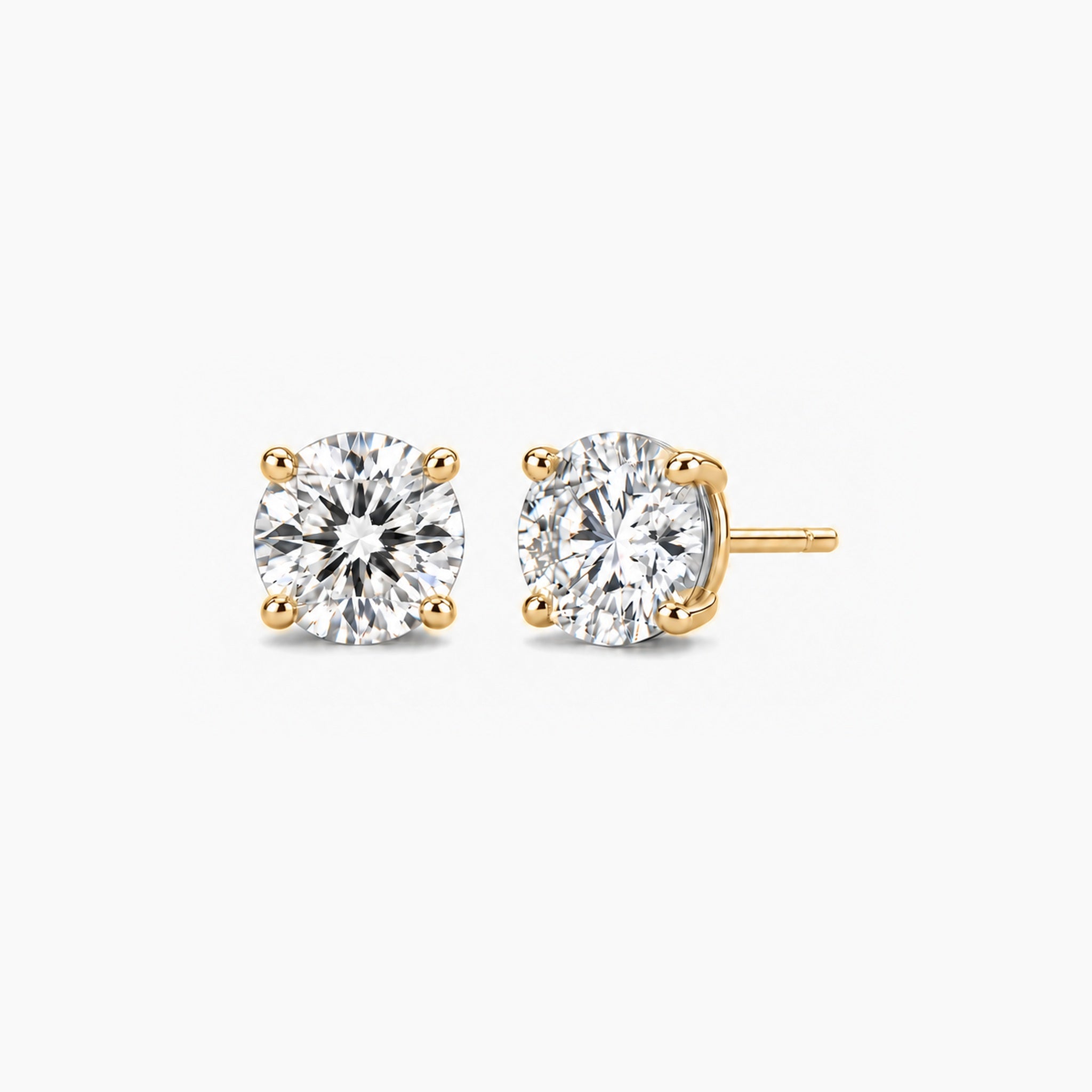 Round-cut lab-grown diamond stud earrings in 14k yellow gold, front and three-quarter views.