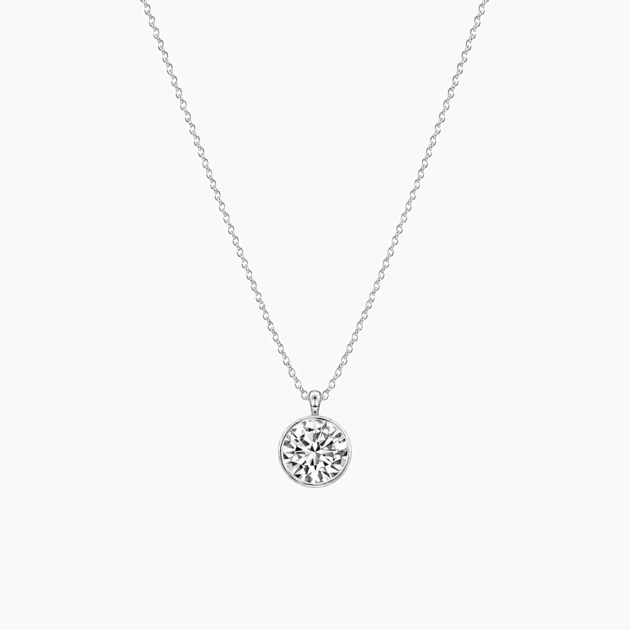Round-cut moissanite bezel pendant necklace in white gold vermeil, full product view.