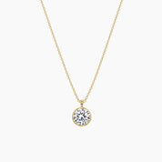 Round-cut moissanite bezel pendant necklace in yellow gold vermeil, full product view.