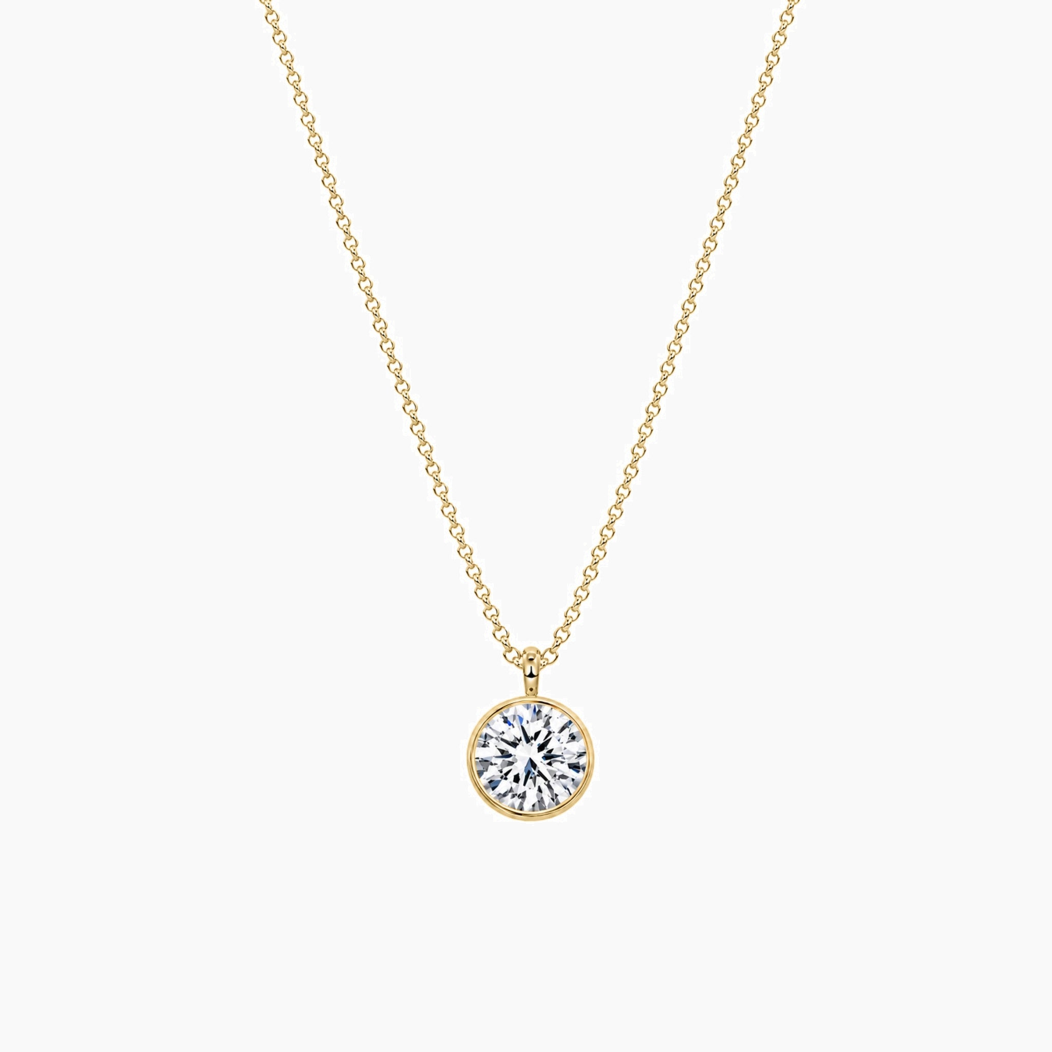 Round-cut moissanite bezel pendant necklace in yellow gold vermeil, full product view.
