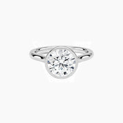 Round-cut moissanite bezel solitaire ring in white gold vermeil, front view.
