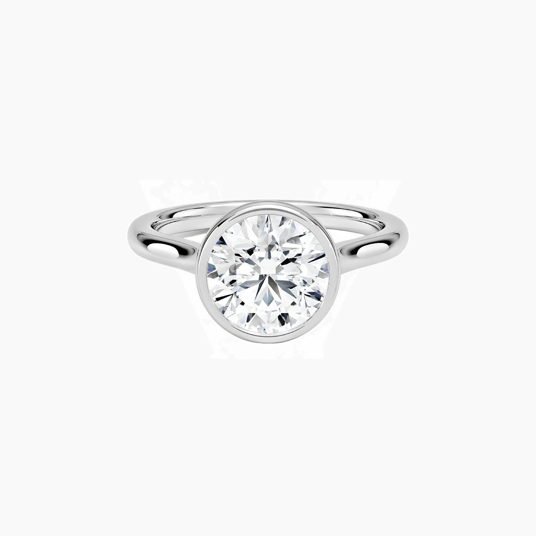 Round-cut moissanite bezel solitaire ring in white gold vermeil, front view.
