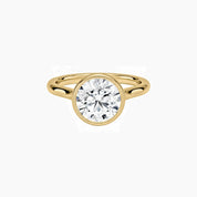 Round-cut moissanite bezel solitaire ring in yellow gold vermeil, front view.