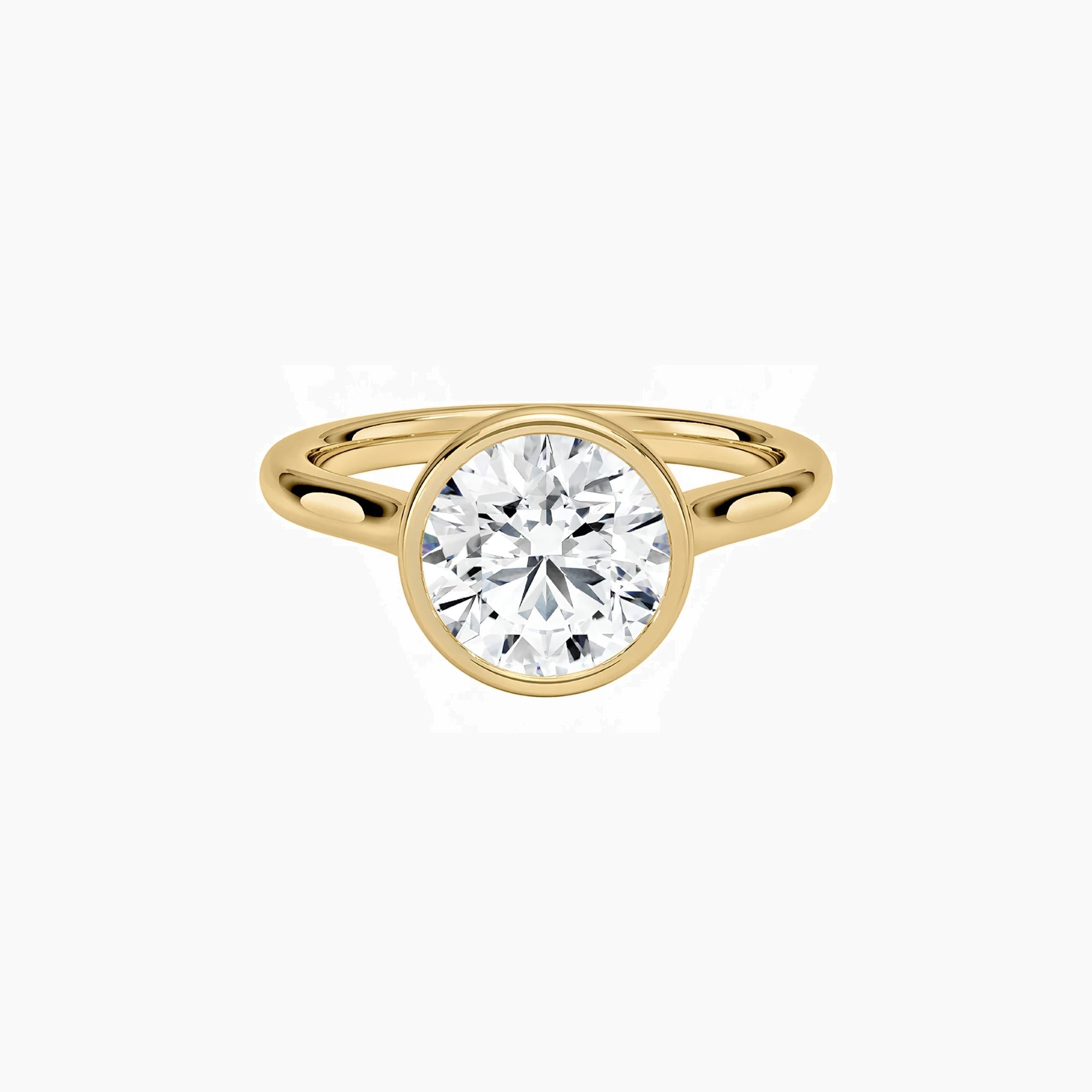 Round-cut moissanite bezel solitaire ring in yellow gold vermeil, front view.