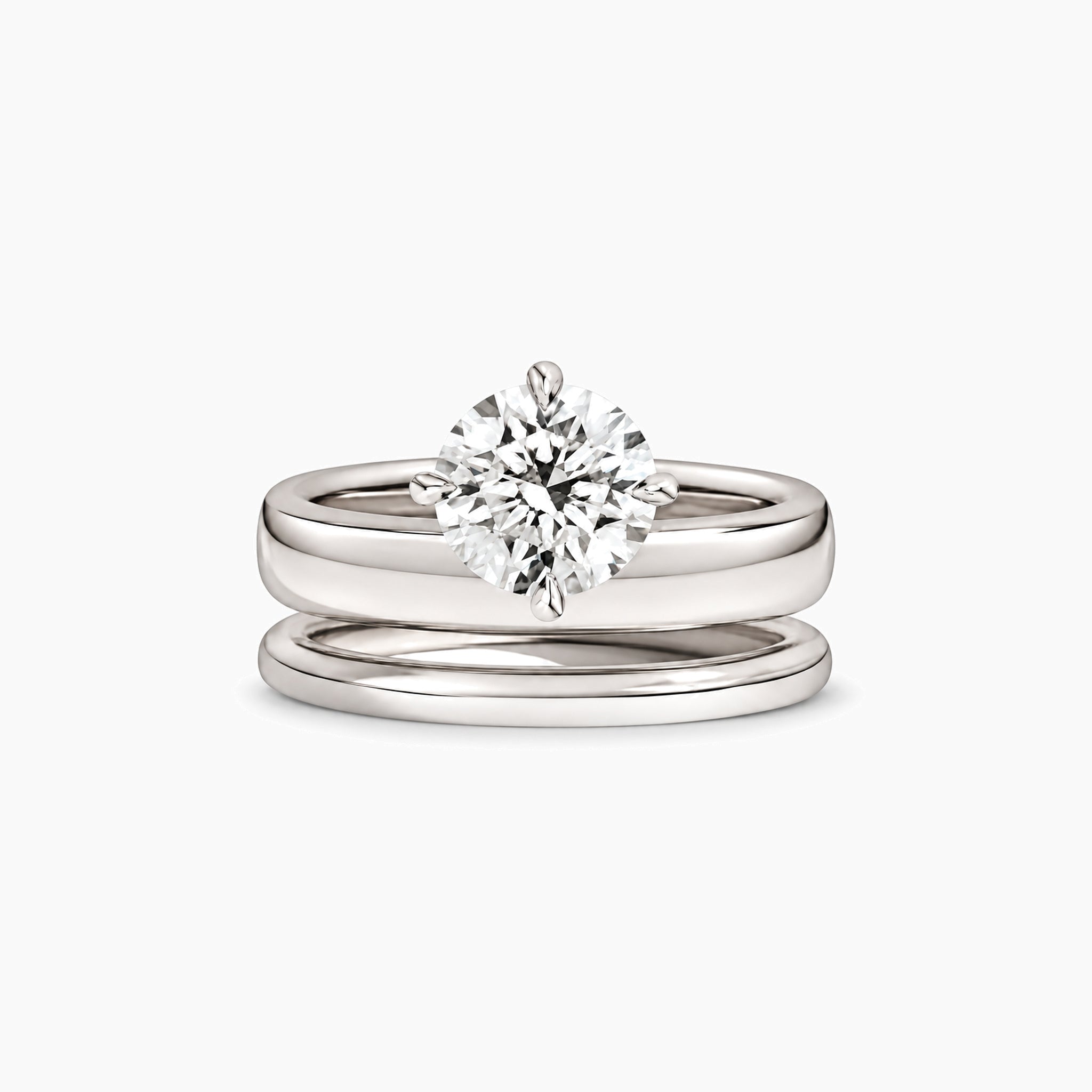 Round-cut moissanite double-band solitaire ring in white gold vermeil, front view.