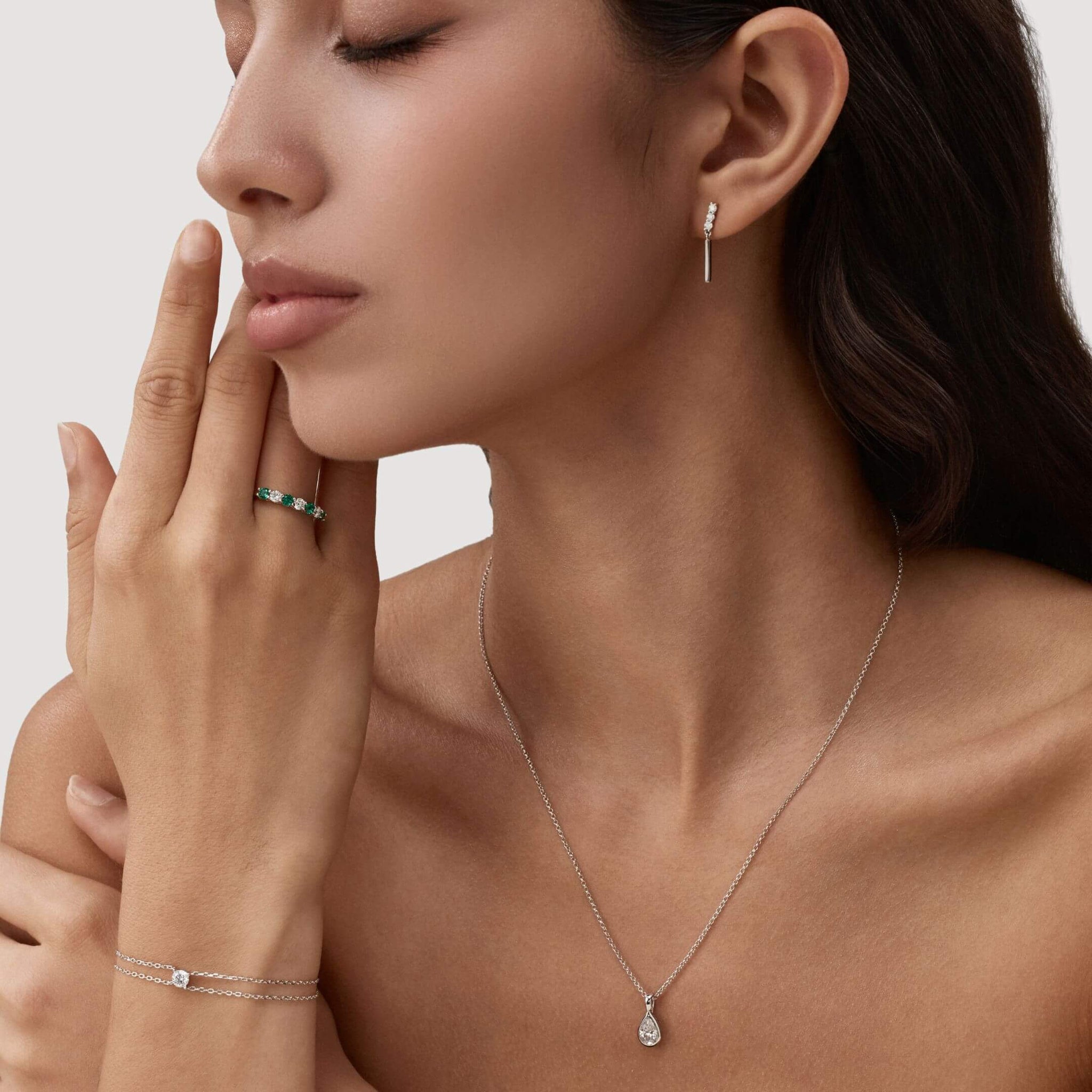 Round-cut moissanite double-chain bracelet worn on the wrist.