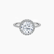 Round-cut moissanite halo ring with pavé band in white gold vermeil, front view.