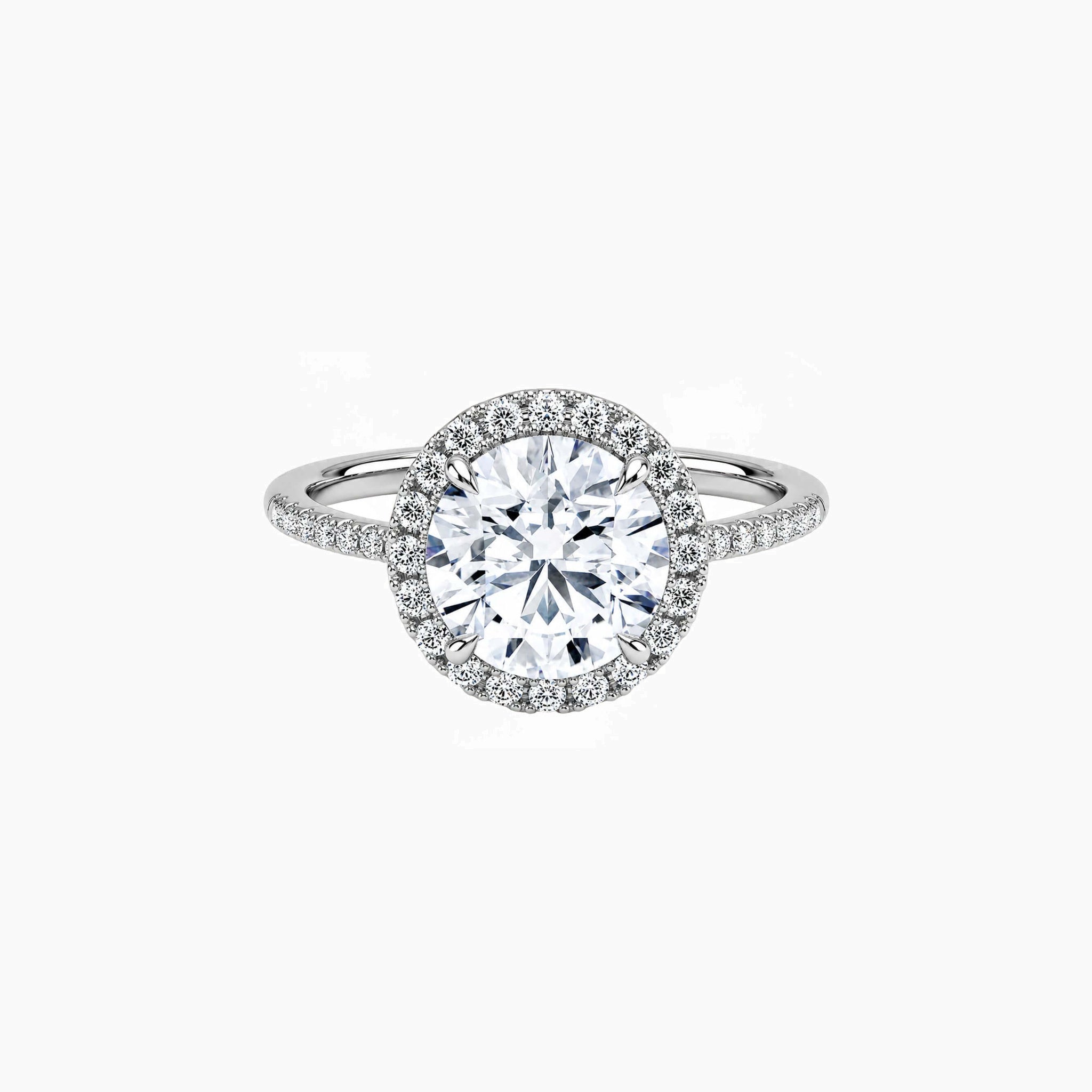 Round-cut moissanite halo ring with pavé band in white gold vermeil, front view.