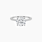 Round-cut moissanite hidden halo ring with pavé band in white gold vermeil, front view.