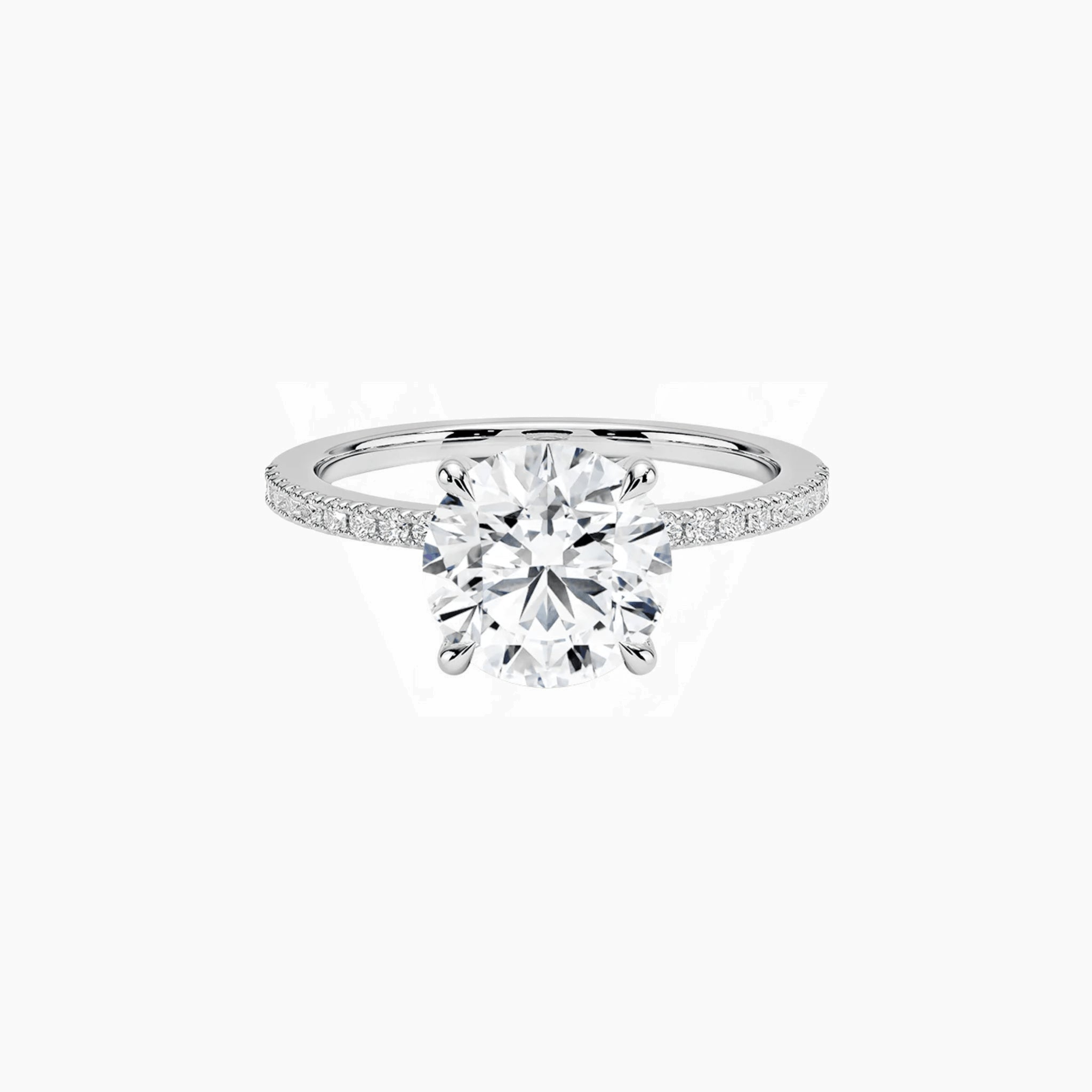 Round-cut moissanite hidden halo ring with pavé band in white gold vermeil, front view.