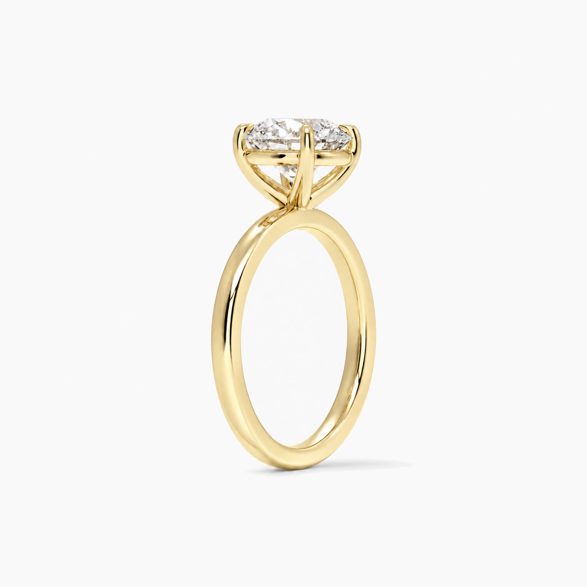 Round-cut moissanite solitaire ring in yellow gold vermeil, side view